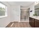 Bright bathroom features a glass shower, luxury vinyl flooring and fresh paint at 234 Robert Howe Dr, Fuquay Varina, NC 27526