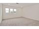 Bright bedroom showcasing plush carpet, three large windows and ample lighting at 234 Robert Howe Dr, Fuquay Varina, NC 27526