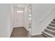 Bright foyer with wood floors, a staircase, and a clear view of the front door and main living areas at 234 Robert Howe Dr, Fuquay Varina, NC 27526