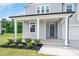 Inviting home exterior with a covered front porch, manicured landscaping, and a charming entrance at 234 Robert Howe Dr, Fuquay Varina, NC 27526