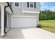 Two car garage and driveway with an inviting gray exterior and manicured lawn at 234 Robert Howe Dr, Fuquay Varina, NC 27526