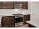 Modern kitchen with stainless steel appliances, granite countertops, and sleek dark wood cabinets at 234 Robert Howe Dr, Fuquay Varina, NC 27526