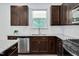 Well-equipped kitchen featuring stainless steel dishwasher, granite countertops, and stylish wood cabinetry at 234 Robert Howe Dr, Fuquay Varina, NC 27526
