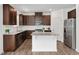 Stylish kitchen featuring stainless steel appliances, a central island, granite counters, and wood cabinets at 234 Robert Howe Dr, Fuquay Varina, NC 27526