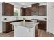 Beautiful kitchen featuring granite countertops, an island, stainless steel appliances, and dark wood cabinets at 234 Robert Howe Dr, Fuquay Varina, NC 27526