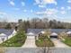 Aerial view of homes with well-maintained lawns, driveways, and mature trees at 2424 Cambridge Rd, Burlington, NC 27215