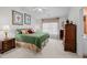 Well-lit bedroom with a ceiling fan and neutral carpet at 2424 Cambridge Rd, Burlington, NC 27215