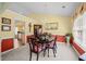 Elegant dining room featuring decorative chandelier, hardwood floors and yellow accent wall at 2424 Cambridge Rd, Burlington, NC 27215