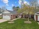 Attractive brick and siding townhome with a two-car garage and a lush green lawn at 2424 Cambridge Rd, Burlington, NC 27215