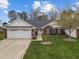 Beautiful one story brick townhome features an attached two car garage and a well manicured lawn at 2424 Cambridge Rd, Burlington, NC 27215