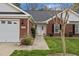 Charming brick townhome with a well-manicured lawn and an inviting front entrance at 2424 Cambridge Rd, Burlington, NC 27215