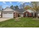 Charming one-story brick home featuring an attached garage and a well-maintained front lawn at 2424 Cambridge Rd, Burlington, NC 27215
