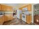 Cozy eat-in kitchen with tile floors and cabinets with white appliances at 2424 Cambridge Rd, Burlington, NC 27215