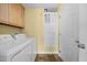 Laundry room with yellow walls, cabinetry, and washer and dryer at 2424 Cambridge Rd, Burlington, NC 27215