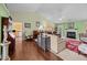 Open-concept living room showcasing hardwood floors, a fireplace, and access to the kitchen at 2424 Cambridge Rd, Burlington, NC 27215