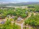 Aerial view of the property showcasing its location amidst lush greenery and near a scenic lake at 251 Gentry Dr, Pittsboro, NC 27312