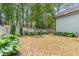 A serene backyard is surrounded by lush greenery, offering privacy and a connection with nature at 251 Gentry Dr, Pittsboro, NC 27312