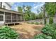 Backyard with a screened porch and a neatly landscaped garden, providing a private outdoor living space at 251 Gentry Dr, Pittsboro, NC 27312