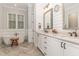 Bright bathroom features a double vanity, soaking tub, and modern fixtures at 251 Gentry Dr, Pittsboro, NC 27312