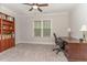 Bedroom with a ceiling fan, neutral carpeting, window with blinds, and a built-in bookshelf at 251 Gentry Dr, Pittsboro, NC 27312