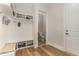 Mudroom with hardwood floors, built-in storage, coat hooks, and a view into the powder room at 251 Gentry Dr, Pittsboro, NC 27312