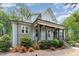 Beautiful home featuring a welcoming front porch, stone accents, and professional landscaping at 251 Gentry Dr, Pittsboro, NC 27312