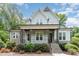 Charming two-story home with stone accents, a covered porch, and professional landscaping at 251 Gentry Dr, Pittsboro, NC 27312