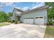 Spacious three-car garage with ample driveway parking and tasteful exterior finishes at 251 Gentry Dr, Pittsboro, NC 27312
