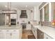 Modern kitchen features stainless steel appliances, white cabinetry, and hardwood floors at 251 Gentry Dr, Pittsboro, NC 27312