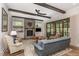 Cozy living room with a stone fireplace, exposed beams, and natural light at 251 Gentry Dr, Pittsboro, NC 27312