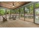The screened-in porch features a wood ceiling, ceiling fan, wood floors, and views of the wooded backyard at 251 Gentry Dr, Pittsboro, NC 27312