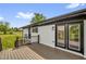 A back deck with outdoor seating, views and stylish sliding glass doors at 2710 E Greensboro Chapel Hill Rd, Snow Camp, NC 27349