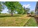 A spacious and well-manicured lawn extends to a wooded property line at 2710 E Greensboro Chapel Hill Rd, Snow Camp, NC 27349