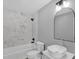 This renovated bathroom features a marble tiled shower and a modern vanity at 2710 E Greensboro Chapel Hill Rd, Snow Camp, NC 27349