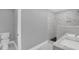 Modern bathroom features luxurious marble tile, a shower, and a double sink vanity at 2710 E Greensboro Chapel Hill Rd, Snow Camp, NC 27349
