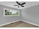 This bright bedroom has two large windows and a ceiling fan at 2710 E Greensboro Chapel Hill Rd, Snow Camp, NC 27349