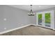 Bright dining area with stylish chandelier and sliding doors to the deck at 2710 E Greensboro Chapel Hill Rd, Snow Camp, NC 27349