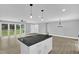 Open-concept kitchen island flows into the spacious living area with recessed lighting at 2710 E Greensboro Chapel Hill Rd, Snow Camp, NC 27349