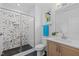 Modern bathroom featuring stylish black and white tile and a glass-enclosed shower with a rain shower head at 30 Futrell Ridge Ct, Chapel Hill, NC 27517