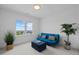 Bright bedroom with scenic window views features a blue futon and leafy plants at 30 Futrell Ridge Ct, Chapel Hill, NC 27517