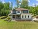 Stunning two-story home with a well-kept lawn and elegant stone detailing on the exterior at 30 Futrell Ridge Ct, Chapel Hill, NC 27517
