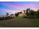Expansive two-story home with professional landscaping on a grassy hill at sunset at 30 Futrell Ridge Ct, Chapel Hill, NC 27517