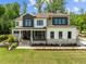 Beautiful two-story home with stone accents, manicured lawn, and modern design elements at 30 Futrell Ridge Ct, Chapel Hill, NC 27517