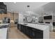Open concept kitchen with large island, modern appliances, and seamless living area at 30 Futrell Ridge Ct, Chapel Hill, NC 27517