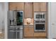 Modern kitchen featuring stainless steel appliances, wooden cabinets, and tiled backsplash at 30 Futrell Ridge Ct, Chapel Hill, NC 27517
