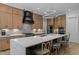 Spacious kitchen featuring a large island with seating, wooden cabinets, and modern appliances at 30 Futrell Ridge Ct, Chapel Hill, NC 27517