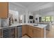 Kitchen with stainless steel beverage center, quartz counters, and open floor plan at 30 Futrell Ridge Ct, Chapel Hill, NC 27517