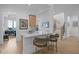 Bright kitchen with island, quartz countertop, and counter seating near the open staircase at 30 Futrell Ridge Ct, Chapel Hill, NC 27517