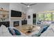 Cozy living room with a fireplace, mounted TV, sliding doors to an outdoor patio, and stylish decor at 30 Futrell Ridge Ct, Chapel Hill, NC 27517