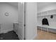Well-organized mudroom with coat hooks, bench, and storage, connecting to the laundry area at 30 Futrell Ridge Ct, Chapel Hill, NC 27517